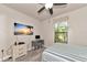 Comfortable bedroom featuring a striped bedspread, mounted flatscreen, and small desk at 2352 Marton Oak Blvd, North Port, FL 34289