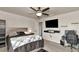 Modern bedroom with large bed, wall-mounted TV, and a sleek gamer setup at 2352 Marton Oak Blvd, North Port, FL 34289
