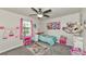 Bright bedroom featuring a ceiling fan, large window, and colorful decor at 2352 Marton Oak Blvd, North Port, FL 34289