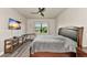 Cozy bedroom featuring a sleek ceiling fan, and a large window offering natural light, creating a relaxing retreat at 2352 Marton Oak Blvd, North Port, FL 34289