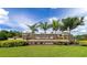 Community entrance sign with lush landscaping and stone accents, welcoming you to a beautiful neighborhood at 2352 Marton Oak Blvd, North Port, FL 34289