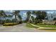 Entrance to community featuring stone signage, mature trees, and manicured landscaping at 2352 Marton Oak Blvd, North Port, FL 34289