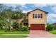 Two-story house with red garage door and landscaping at 2352 Marton Oak Blvd, North Port, FL 34289
