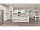 Bright kitchen with modern appliances, a stylish island with a white and gray wood accent, pendant lighting, and a spacious pantry at 2352 Marton Oak Blvd, North Port, FL 34289