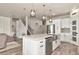 Bright kitchen features a large island, white cabinets, stainless steel appliances, and decorative backsplash at 2352 Marton Oak Blvd, North Port, FL 34289