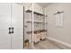 Well-organized laundry room with ample shelving, storage, and modern design for efficient and stylish chore space at 2352 Marton Oak Blvd, North Port, FL 34289