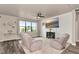 Cozy living room featuring a large window, comfortable seating, a ceiling fan, and modern decor at 2352 Marton Oak Blvd, North Port, FL 34289