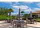 Outdoor patio area with tables, chairs, umbrellas, and a grill, perfect for entertaining at 2352 Marton Oak Blvd, North Port, FL 34289