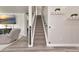 Inviting staircase leading to the upper level, enhanced with wall decor and cozy adjacent living space at 2352 Marton Oak Blvd, North Port, FL 34289