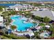 Overhead view of the expansive pool and clubhouse surrounded by palm trees and cabanas at 3107 Vittorio Ct, Bradenton, FL 34211