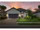 Beautiful single-story home featuring a tile roof, manicured lawn, and a paver driveway leading to a two-car garage at 3107 Vittorio Ct, Bradenton, FL 34211
