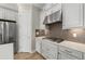 Kitchen with white cabinets, stainless steel appliances, and a stylish backsplash, showcasing modern design at 3107 Vittorio Ct, Bradenton, FL 34211