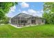 Enclosed pool area and expansive grassy backyard with lush landscaping at 6935 Cumberland Ter, University Park, FL 34201