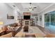 Cozy living room with a stone fireplace and large TV at 6935 Cumberland Ter, University Park, FL 34201