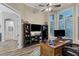 Home office with wood desk, built-in shelving, and two monitors at 6935 Cumberland Ter, University Park, FL 34201
