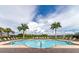 Community pool with lounge chairs and palm trees at 2352 Marton Oak Blvd, North Port, FL 34289