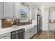 Modern kitchen with farmhouse sink, stainless steel appliances, and herringbone backsplash at 3107 Vittorio Ct, Bradenton, FL 34211