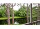 Enjoy serene pond views from the screened back porch, surrounded by lush greenery at 4751 Travini Circle # 4-116, Sarasota, FL 34235