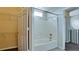 Bright bathroom features a tub and shower combo, plus a convenient built-in shelf for toiletries at 4751 Travini Circle # 4-116, Sarasota, FL 34235