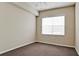 Bright bedroom featuring a ceiling fan, carpet and large window with natural light at 4751 Travini Circle # 4-116, Sarasota, FL 34235