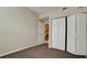 Cozy bedroom with neutral walls, carpeting, closet, and a view to stairs at 4751 Travini Circle # 4-116, Sarasota, FL 34235