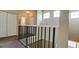 Upper level hallway with view down to lower level and closet space at 4751 Travini Circle # 4-116, Sarasota, FL 34235