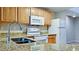 Well-equipped kitchen featuring granite countertops and modern white appliances at 4751 Travini Circle # 4-116, Sarasota, FL 34235