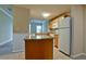 Spacious kitchen featuring granite island, modern appliances, and an open view to the living area at 4751 Travini Circle # 4-116, Sarasota, FL 34235