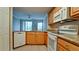Open kitchen with granite countertops, white appliances, and ample cabinet space at 4751 Travini Circle # 4-116, Sarasota, FL 34235