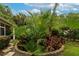 Lush backyard featuring a garden with tropical plants and stone pathway at 7418 Monte Verde, Sarasota, FL 34238