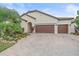 Two-story house exterior with three car garage and manicured landscaping at 16922 Scuba Crest St, Wimauma, FL 33598