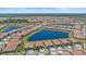 Aerial view of community with lake and numerous houses at 16922 Scuba Crest St, Wimauma, FL 33598