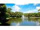 Serene lake with a fountain and lush greenery at 4751 Travini Circle # 4-116, Sarasota, FL 34235