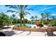 Relaxing pool area with landscaping and lounge chairs at 4751 Travini Circle # 4-116, Sarasota, FL 34235