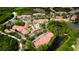 Aerial view showing condo's location near water and lush landscaping at 4751 Travini Circle # 4-116, Sarasota, FL 34235