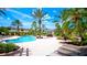 Resort-style pool with lounge chairs and lush landscaping at 4751 Travini Circle # 4-116, Sarasota, FL 34235