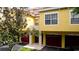 Exterior view of yellow building with two garages at 4751 Travini Circle # 4-116, Sarasota, FL 34235