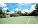 Well-maintained tennis court with surrounding landscape at 4751 Travini Circle # 4-116, Sarasota, FL 34235