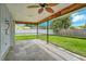 Spacious screened patio with backyard view and ceiling fan at 2480 Mcguffy Cir, Sarasota, FL 34235