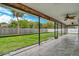 Large screened porch overlooking backyard with ceiling fans at 2480 Mcguffy Cir, Sarasota, FL 34235