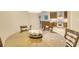 Round glass dining table with four chairs, overlooking the kitchen at 915 Seaside Dr # 607 Weeks 14-15, Sarasota, FL 34242