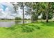 Landscaped backyard with pond view and lush greenery at 5519 Fair Oaks St # 2-D, Bradenton, FL 34203