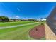 Landscaped backyard with a view of the golf course at 5519 Fair Oaks St # 2-D, Bradenton, FL 34203