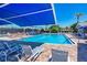 Resort-style pool with lounge chairs and shade umbrellas at 5519 Fair Oaks St # 2-D, Bradenton, FL 34203