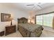 Comfortable bedroom with double bed, nightstands, and large window at 5519 Fair Oaks St # 2-D, Bradenton, FL 34203