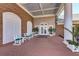 Brick clubhouse entrance with white columns and seating area at 5519 Fair Oaks St # 2-D, Bradenton, FL 34203