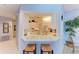 Kitchen with breakfast bar and white cabinets at 5519 Fair Oaks St # 2-D, Bradenton, FL 34203