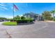 Community clubhouse entrance with landscaping and American flag at 5519 Fair Oaks St # 2-D, Bradenton, FL 34203