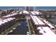 Aerial view showcasing waterfront condos with boat docks and canal access to the ocean at 1300 N Portofino Dr # 208, Sarasota, FL 34242