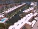 Aerial view featuring condos with a canal and boat docks plus a swimming pool at 1300 N Portofino Dr # 208, Sarasota, FL 34242